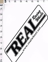 NEW, REAL RACING WHEELS STICKER, 11″ X 3″, BLACK WRITING ON WHITE BACKGROUND