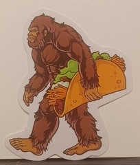Bigfoot/Sasquatch Cryptid With A Taco Glossy Decal Sticker. 2.25″ Tall×2″ Wide