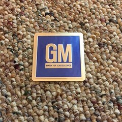 1968 – 1982 GM MARK OF EXCELLENCE EMBOSSED DECAL / EMBLEMS METAL *NEW* PAIR (2)